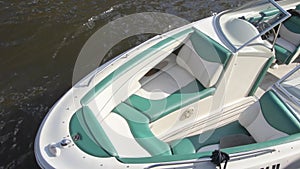 Trip yacht with beautiful white-green salon floating on dock. Sunny day. close up