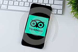 Tripadvisor app logo on a smartphone screen