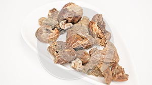 Triphala ayurvedic medicinal plant comprise of chebulic myrobalan fruit on white background with wood mortar and pestle photo