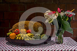 Tripical fruit arrangement and Anthurium on table photo