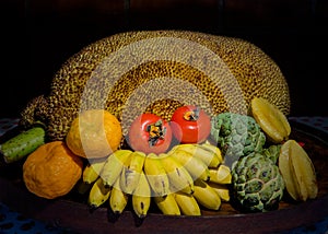 Tripical fruits in wooden bowl photo