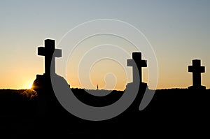 Triple Crosses Silhouettes against the Golden Sunset