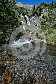 Triple waterfall in a mountain landscape of a river of cold, clear, transparent and crystalline waters photo