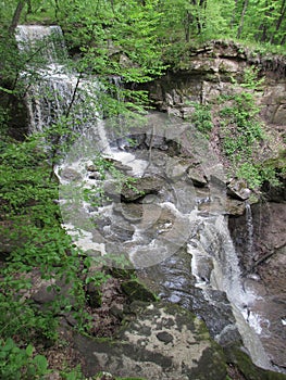 Triple Waterfall over Stone in a Lush Green Forest