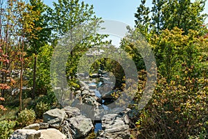 Triple waterfall splits into three streams in Japanese garden. Public landscape park of Krasnodar