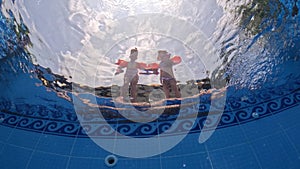 triplet sisters kids jumping in swiming pool