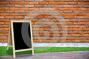 Tripod blackboard in interior room with molder brick wall