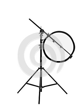 Tripod with studio reflector isolated on white. Professional photographer`s equipment