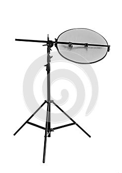 Tripod with studio reflector isolated on white. Professional photographer`s equipment