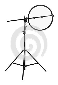 Tripod with studio reflector isolated on white. Professional photographer`s equipment