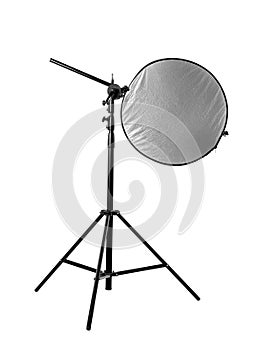 Tripod with studio reflector isolated on white. Professional photographer`s equipment