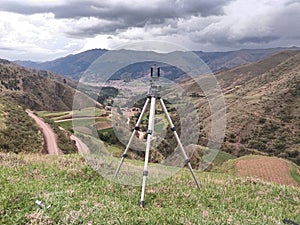 tripode in the foreground and mountains in the background photo