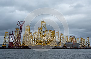 Tripods for supporting wind turbines awaiting relocation in the North Sea, photographed at port in Cromarty, Scotland UK.