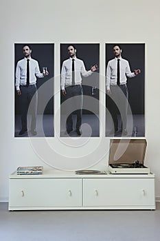 Triptych Above Record Player On Sideboard