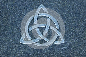 Triquetra / Trinity knot on stone surface