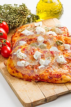 Tris of mixed pizza on wood with ingredients photo