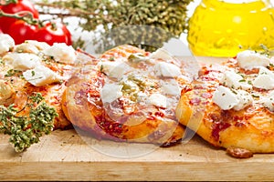 Tris of mixed pizza on wood with ingredients