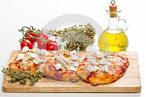 Tris of mixed pizza on wood isolated on white with ingredients photo