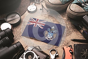 Tristan da Cunha Flag Between Traveler`s Accessories on Old Vintage Map. Tourist Destination Concept