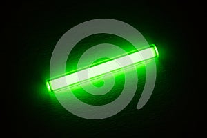 Tritium. Radioactive glow. Gaseous tritium light source in a glass vial. Radiation green glow hazards to employees photo