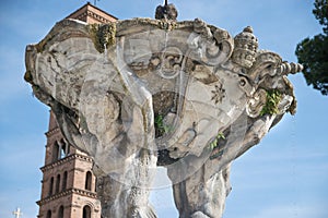 Tritons fountain and Basilica of Saint Mary in Cosmedin