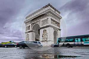 Triumphal arch. Arc de triomphe. View of Place Charles de Gaulle. Famous touristic architecture landmark in rainy day. Long expos