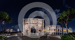 Triumphal Arch of Constantine at night with a dramatic sky in the background, Rome, Italy