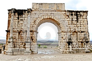 Triumphal arch at ruins of the roman city Volubilis in Morocco photo
