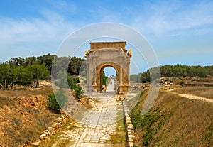 Triumphal Arch of Septimius Severus at ancient Roman ruins of Leptis Magna on the Mediterranean coast of Libya in North Africa photo