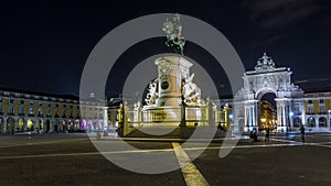 Triumphal arch at Rua Augusta and bronze statue of King Jose I at Commerce square night timelapse hyperlapse in Lisbon