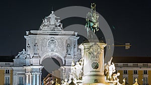 Triumphal arch at Rua Augusta and bronze statue of King Jose I at Commerce square night timelapse in Lisbon, Portugal.