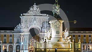 Triumphal arch at Rua Augusta and bronze statue of King Jose I at Commerce square night timelapse in Lisbon, Portugal.