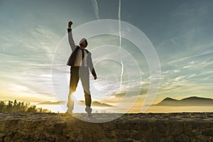 Triumphant businessman greeting a new day photo