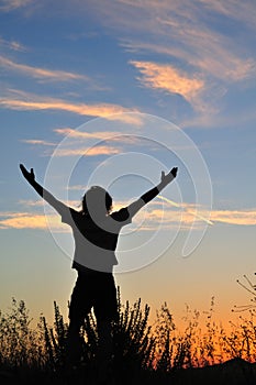 Triumphant man at sunset