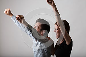 Triumphant man and woman, arms raised (side view