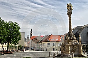 TRNAVA, SLOVAKIA Local and visitor stroll the Trojicne square, near the city tower, In Trnava, Slovakia