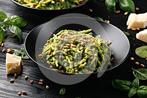 Trofie pasta with creamy spinach sauce and toasted pine nuts