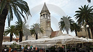 Trogir, Croatia - 07/25/2015 - View of street cafe and St. Dominic Monastery in old town, beautiful architecture, sunny day