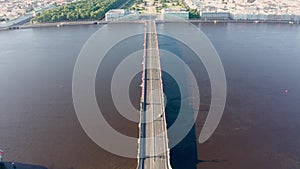 Troitsky Bridge and Palace Embankment along the Neva River. Peter and Paul Fortress on an early summer morning in clear