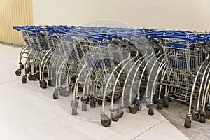Trolley parking in a hypermarket, Light blue shopping carts, Many empty shopping carts in a row
