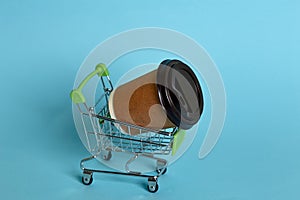 Trolley from the supermarket. A glass of coffee. the concept of less shopping, driving consumer behavior, the effect of