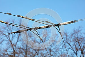 Trolleybus wires against the blue sky