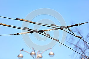 Trolleybus wires against the blue sky