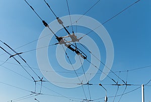 Trolleybus wires against the blue sky.