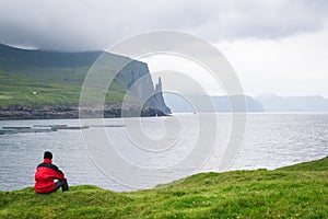 Trollkonufingur rock pillar rising from sea at the coast of Vagar, Faroe Islands