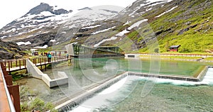 Trollstigen, Andalsnes, Norway. People Tourists Walking Visiting Viewing Platform Near Visitor Centre. Famous Norwegian