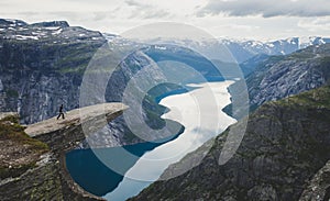 Trolltunga - famous rock formation and tourist famous hike, beautiful norwegian summer landscape with fjord, mountain and lake