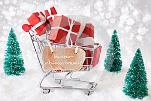 Trolly With Christmas Gifts And Snow, Winterschlussverkauf Means Winter Sale photo