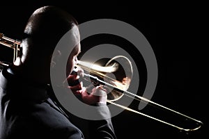 Trombone player. Trombonist playing brass instrument