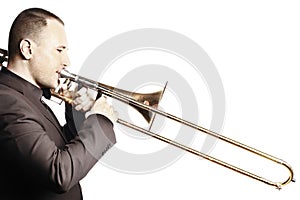 Trombone player. Trombonist playing brass instrument  on white